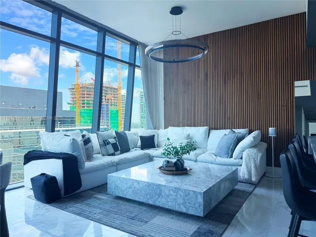 a living room with furniture and a large window