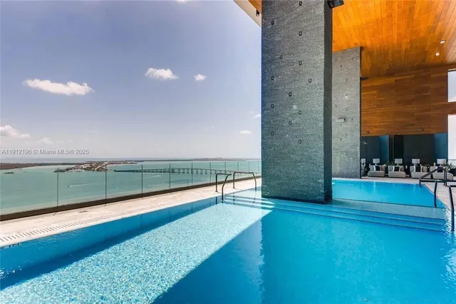 a view of swimming pool with a lounge chairs