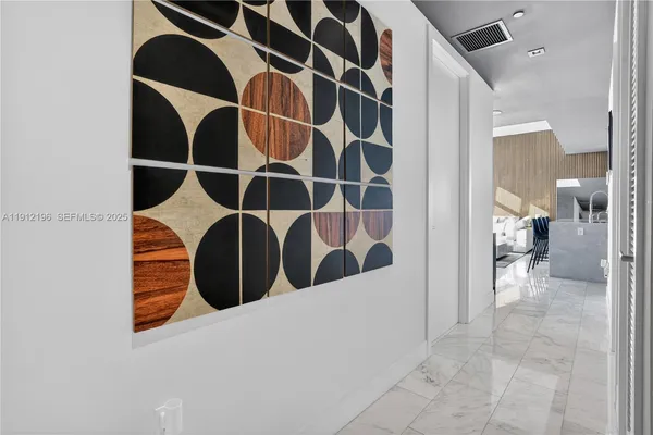 a bedroom with a bed and painting on the wall