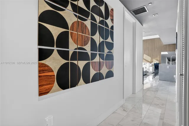 a bedroom with a bed and painting on the wall