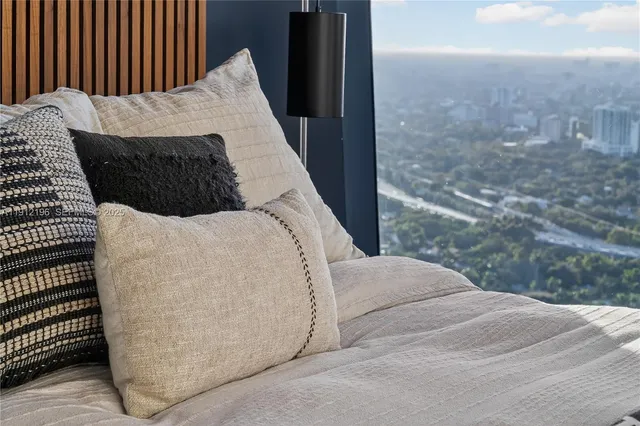 a room with a bed and a large window