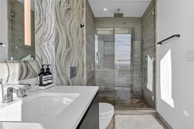 a large kitchen with kitchen island granite countertop a sink and a counter top space