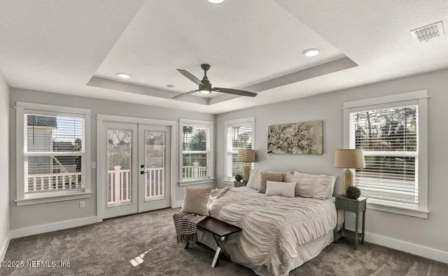 a row of palm trees in front of a house