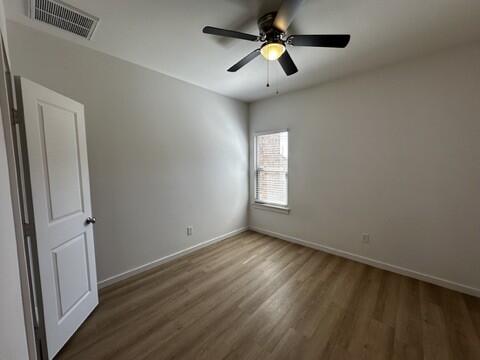 5511 Itasca Street Lubbock, TX 79416 - Photo 12 of 21 wooden floor in an empty room with a window