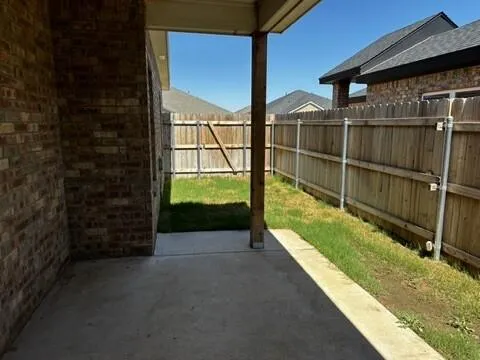 a view of a balcony with a floor to ceiling window and wooden fence