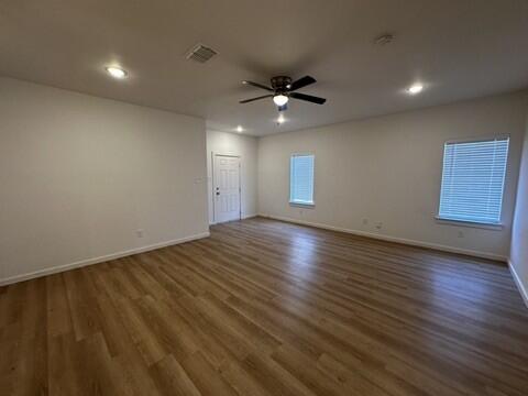 5511 Itasca Street Lubbock, TX 79416 - Photo 2 of 21 wooden floor in an empty room with a window
