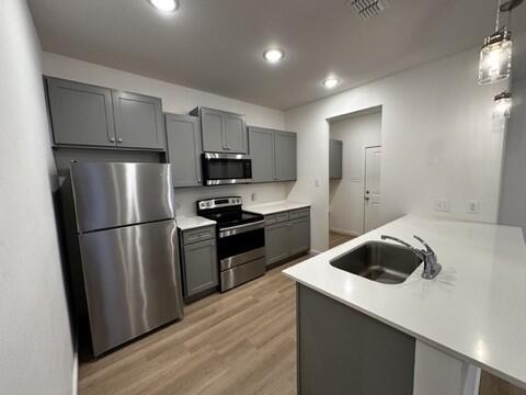 5511 Itasca Street Lubbock, TX 79416 - Photo 4 of 21 a kitchen with a refrigerator a stove and wooden floor