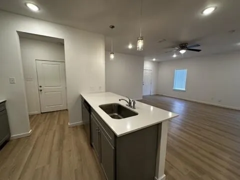 a kitchen with a sink and stove top oven