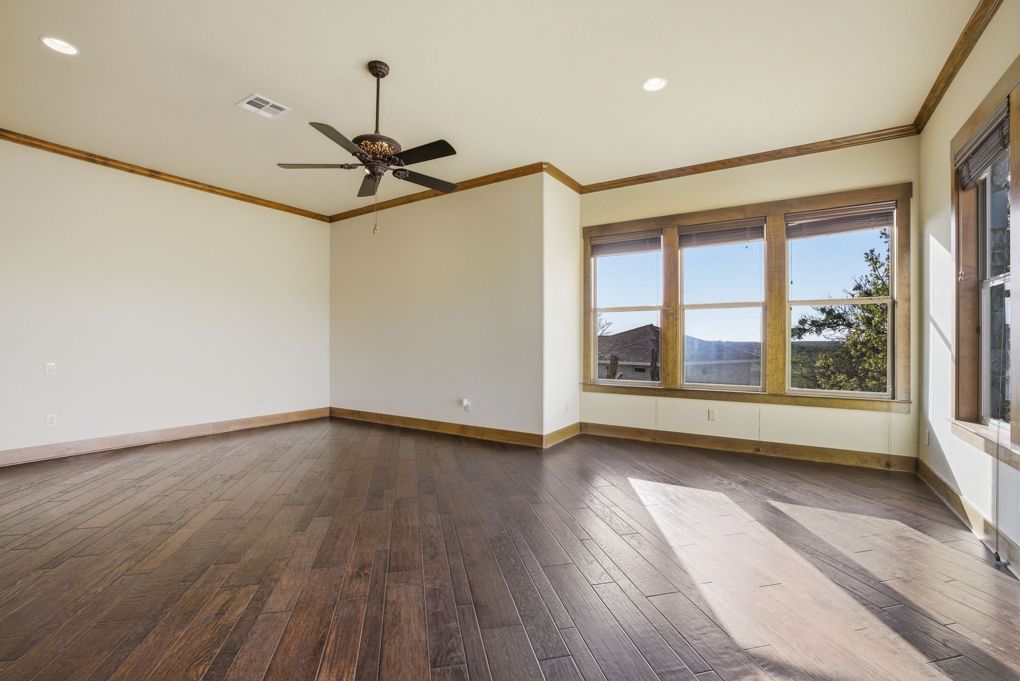 5010 Lookout Ridge Drive Marble Falls, TX 78654 - Photo 19 of 40 Spare room featuring recessed lighting, dark wood-type flooring, ornamental molding, and a ceiling fan