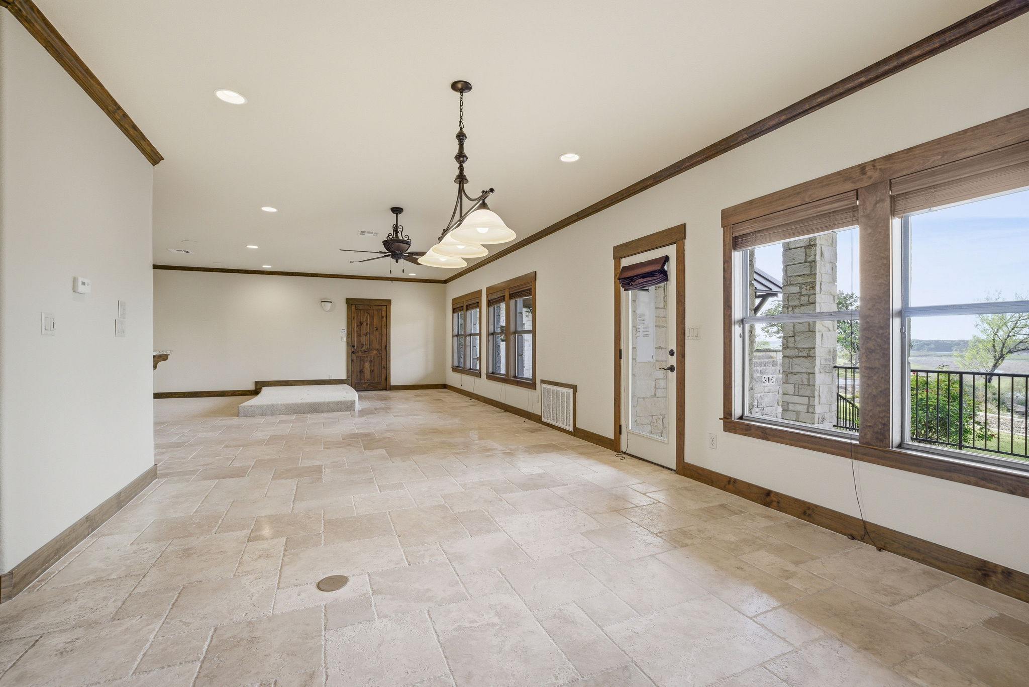 5010 Lookout Ridge Drive Marble Falls, TX 78654 - Photo 22 of 40 Spare room featuring stone tile floors, ornamental molding, recessed lighting, and a ceiling fan