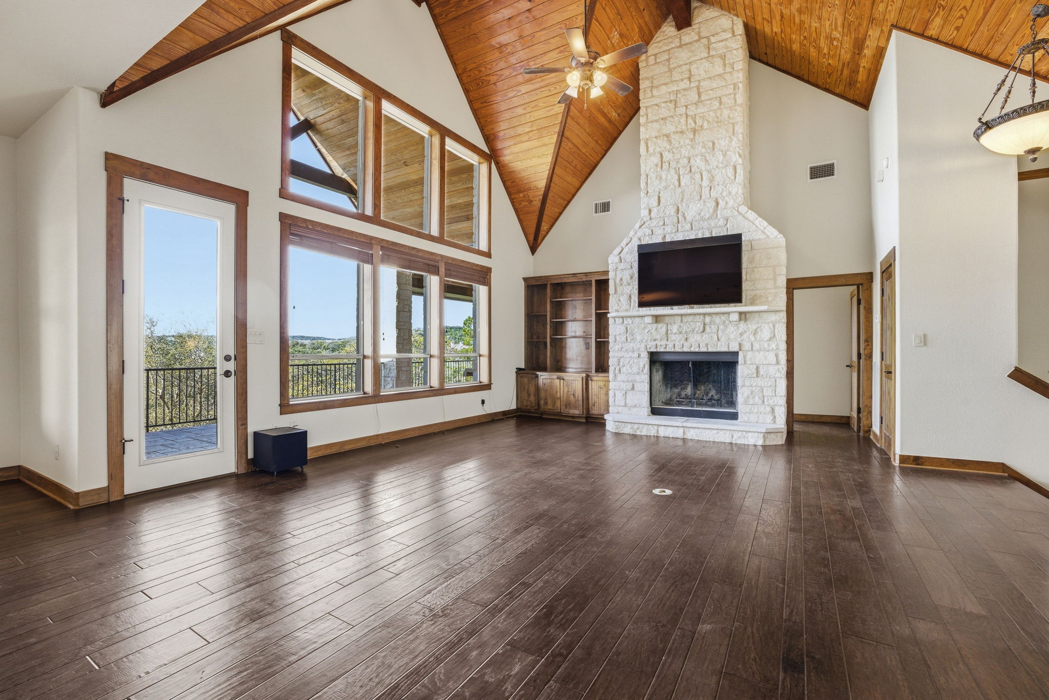 5010 Lookout Ridge Drive Marble Falls, TX 78654 - Photo 26 of 40 Unfurnished living room featuring a ceiling fan, a high wooden beamed ceiling, a fireplace, and dark wood finished floors