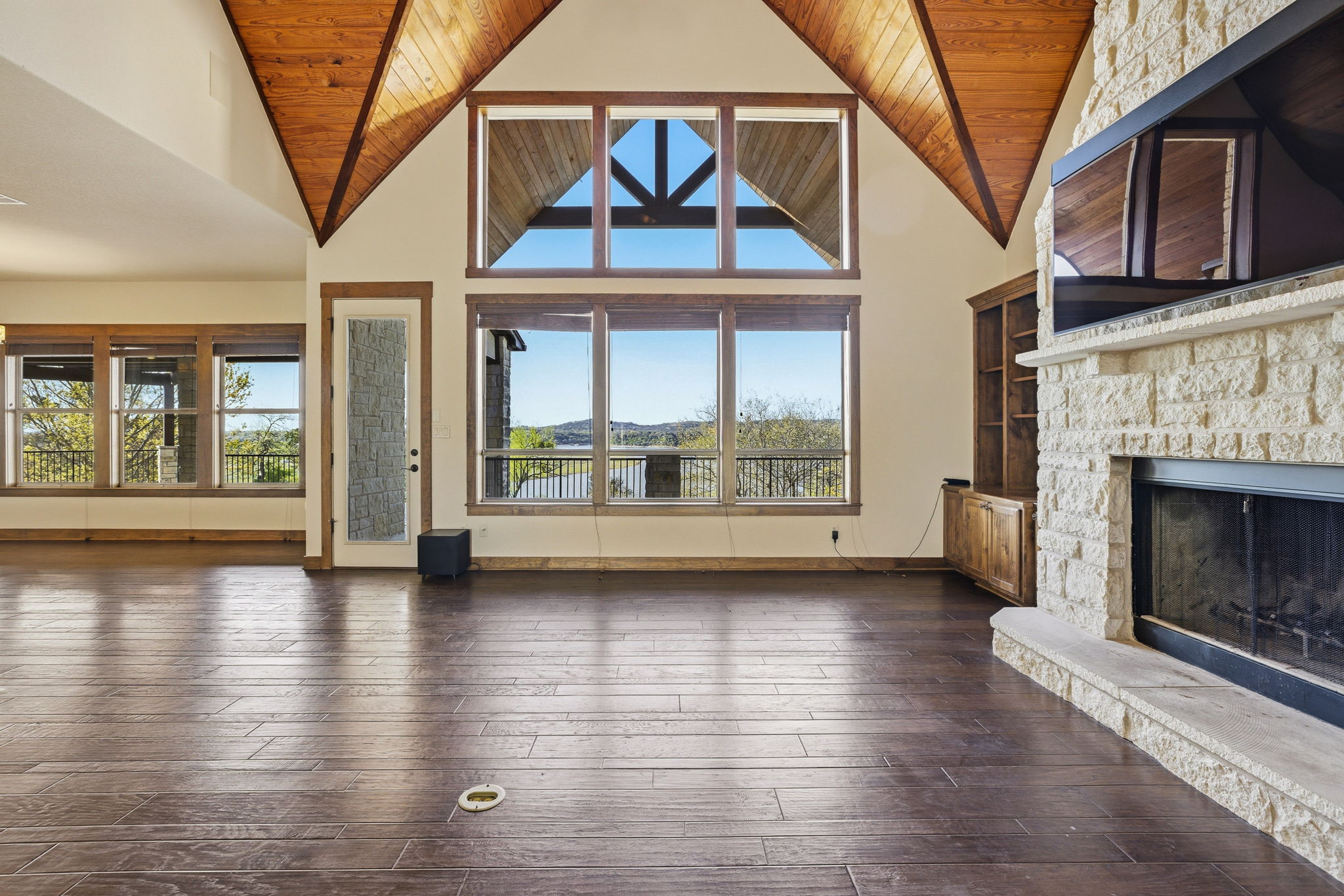 5010 Lookout Ridge Drive Marble Falls, TX 78654 - Photo 27 of 40 Unfurnished living room with a fireplace, a high wooden ceiling, and dark wood-type flooring