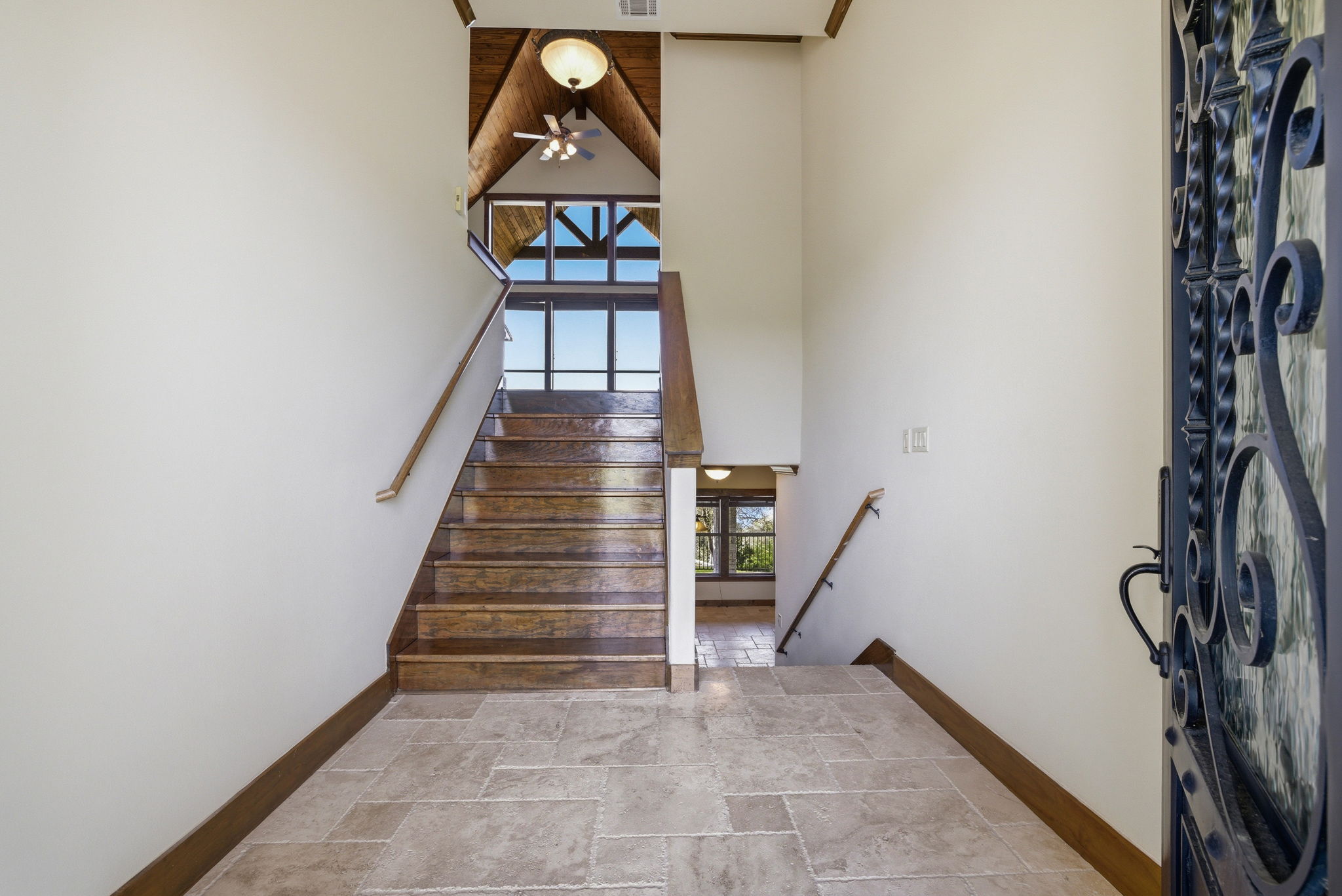 5010 Lookout Ridge Drive Marble Falls, TX 78654 - Photo 28 of 40 Stairway featuring stone tile floors and a high ceiling