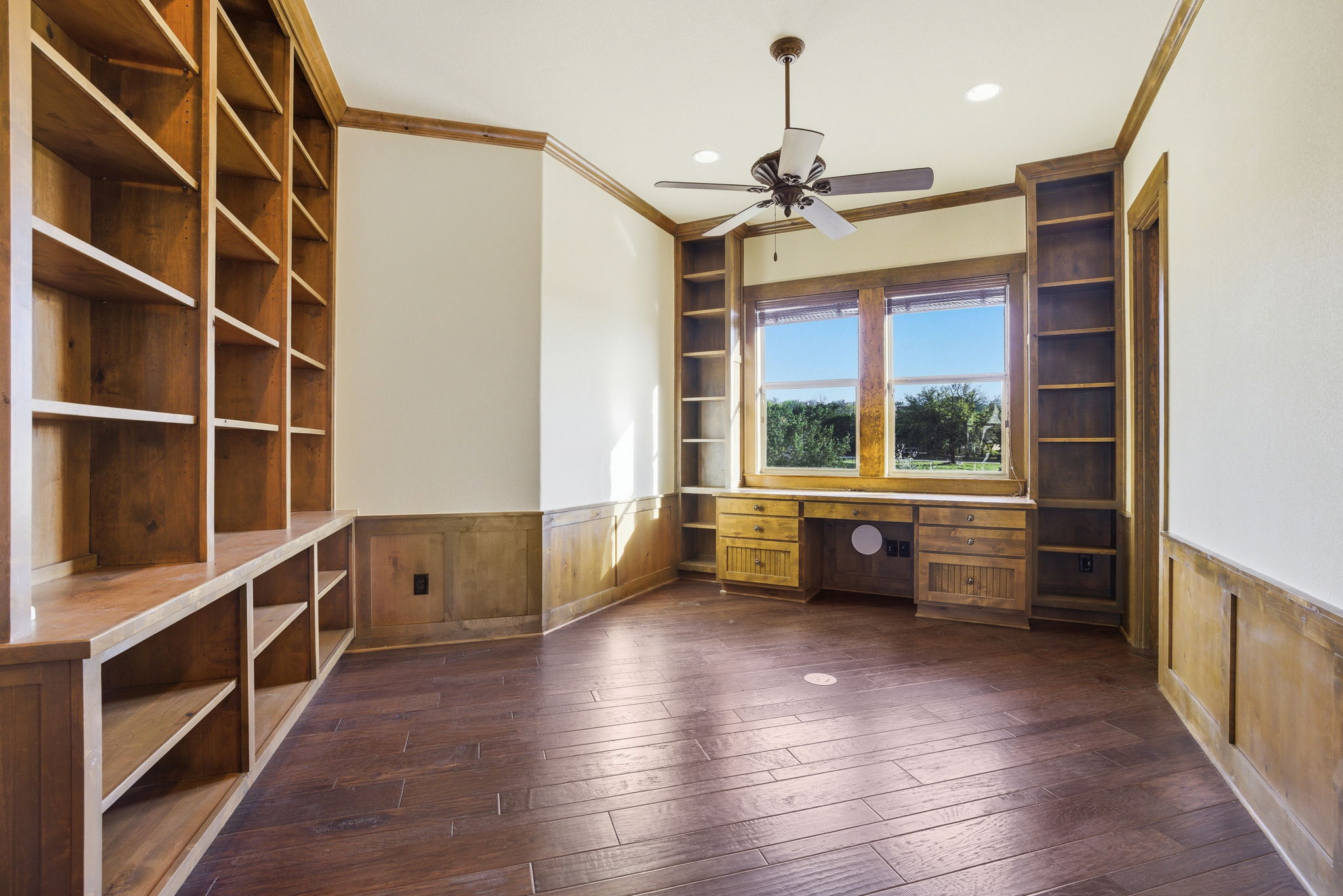 5010 Lookout Ridge Drive Marble Falls, TX 78654 - Photo 35 of 40 Unfurnished office featuring wainscoting, wood walls, built in features, built in study area, and ornamental molding