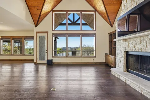 a view of livingroom with furniture wooden floor fire place and window