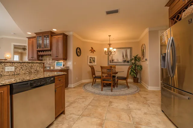 a kitchen with stainless steel appliances granite countertop a stove and cabinets