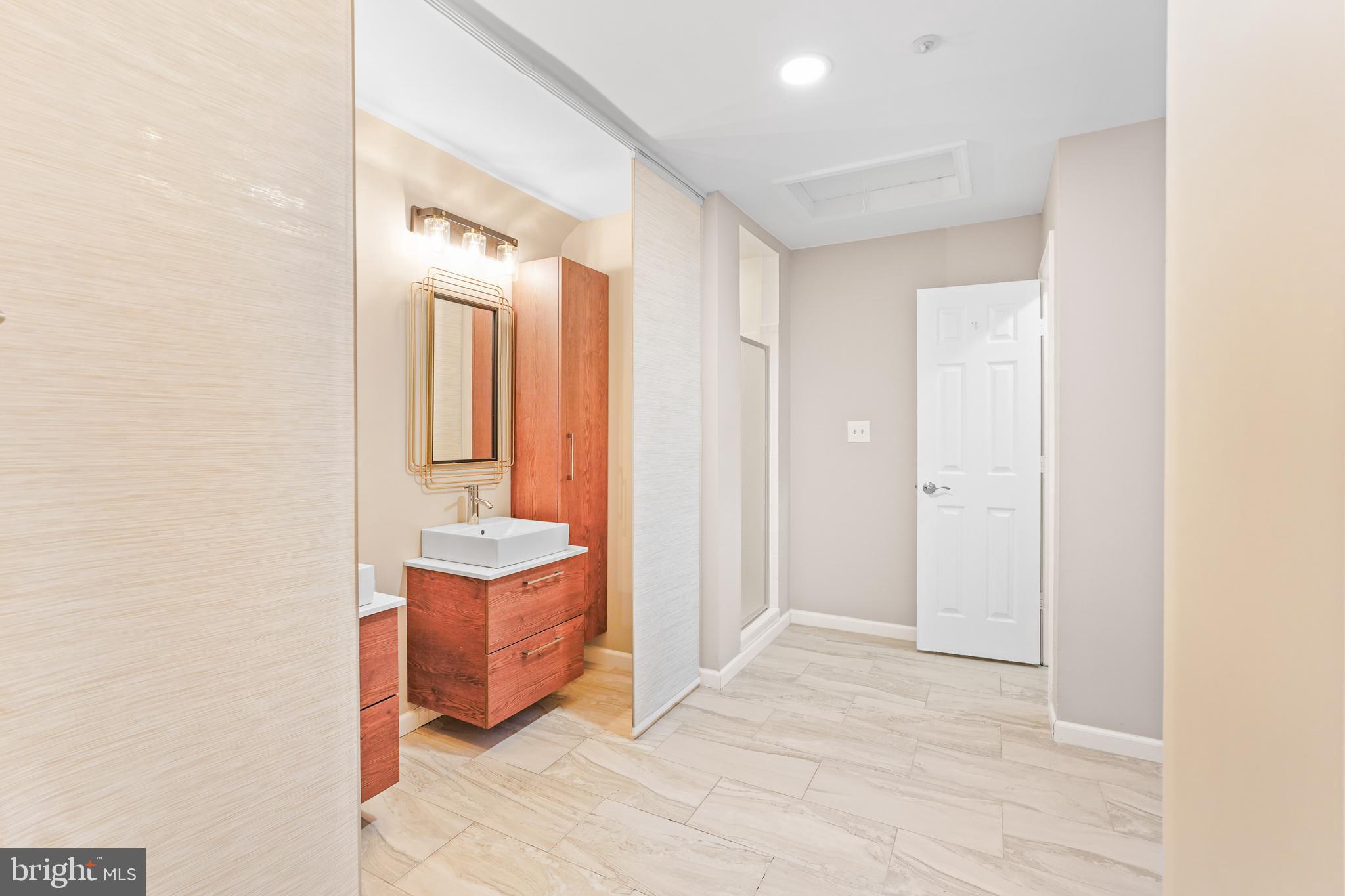596 Chestertown Street Gaithersburg, MD 20878 - Photo 23 of 56 a bathroom with a sink a mirror and a shower