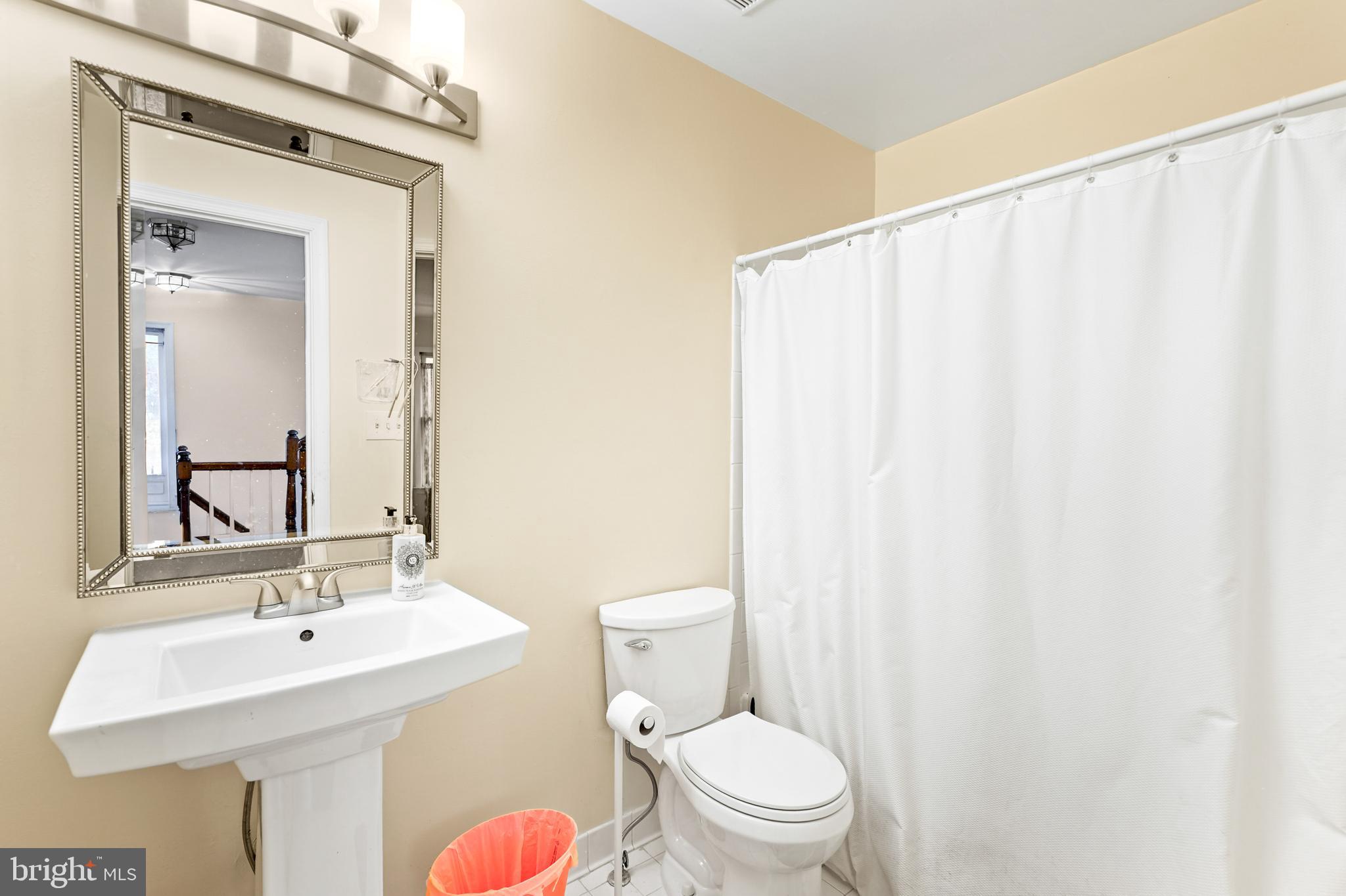 596 Chestertown Street Gaithersburg, MD 20878 - Photo 29 of 56 a bathroom with a sink a toilet and mirror