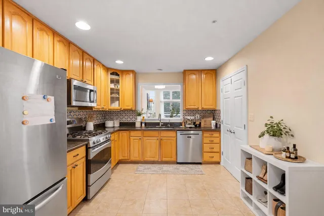 a bedroom with a bed a table and chair