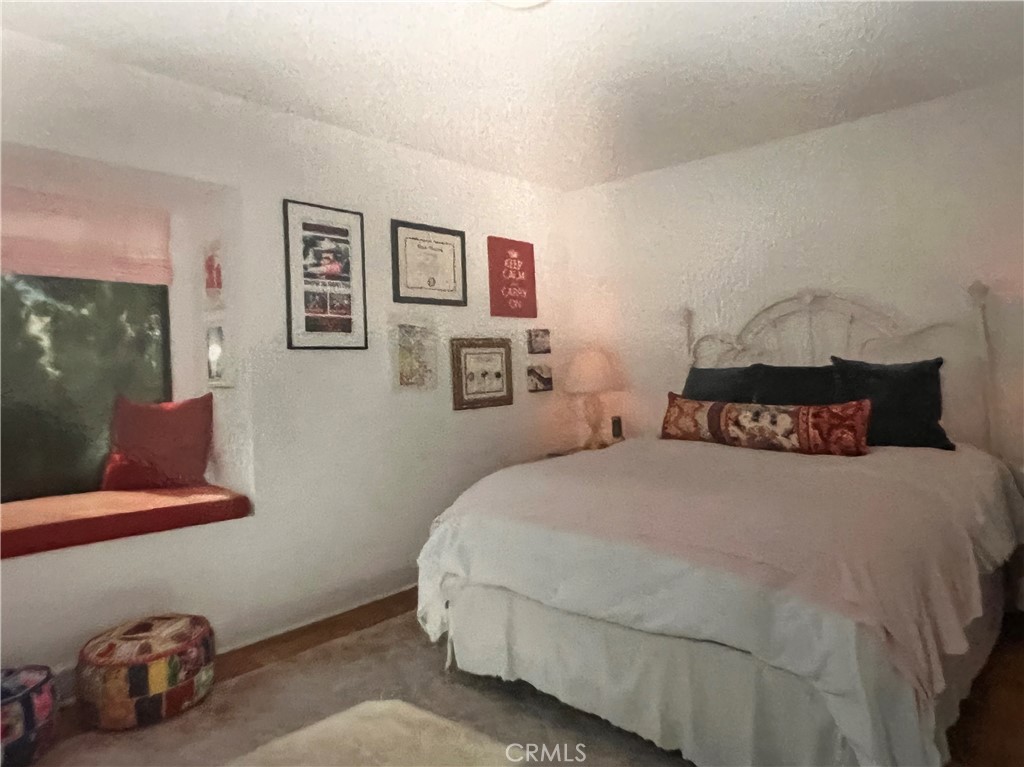 a bedroom with a bed and lamp