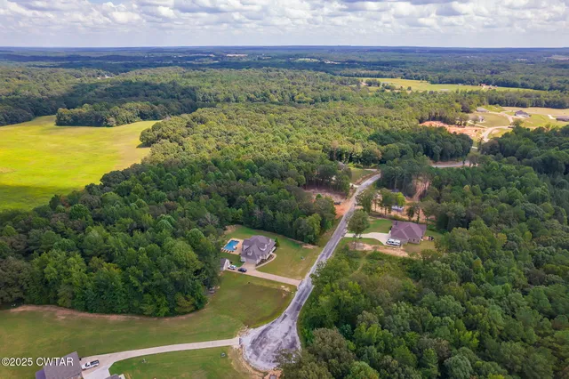 an aerial view of residential house with outdoor space and swimming pool