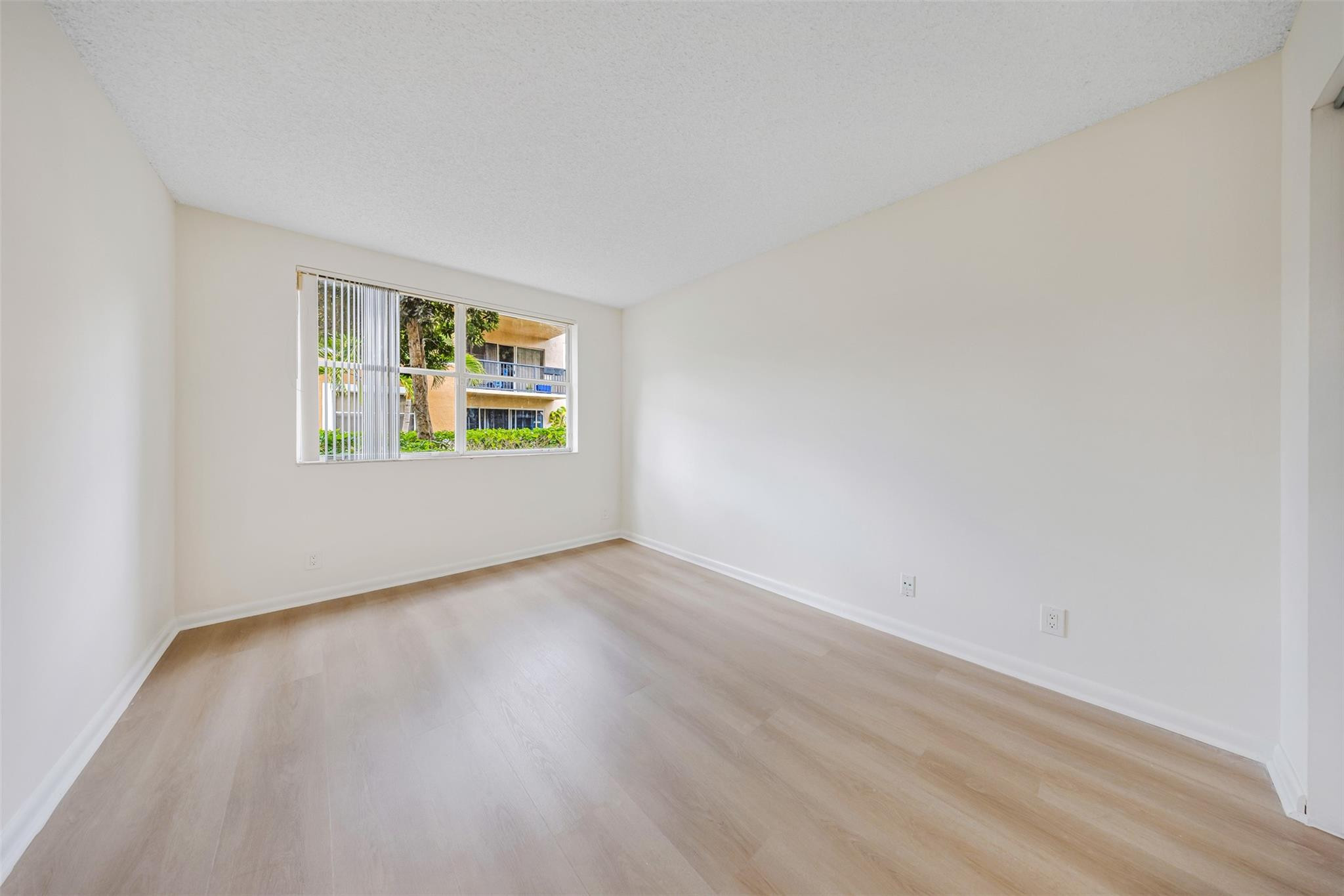 8977 Wiles Road, Unit 102 Coral Springs, FL 33067 - Photo 14 of 37 an empty room with a window