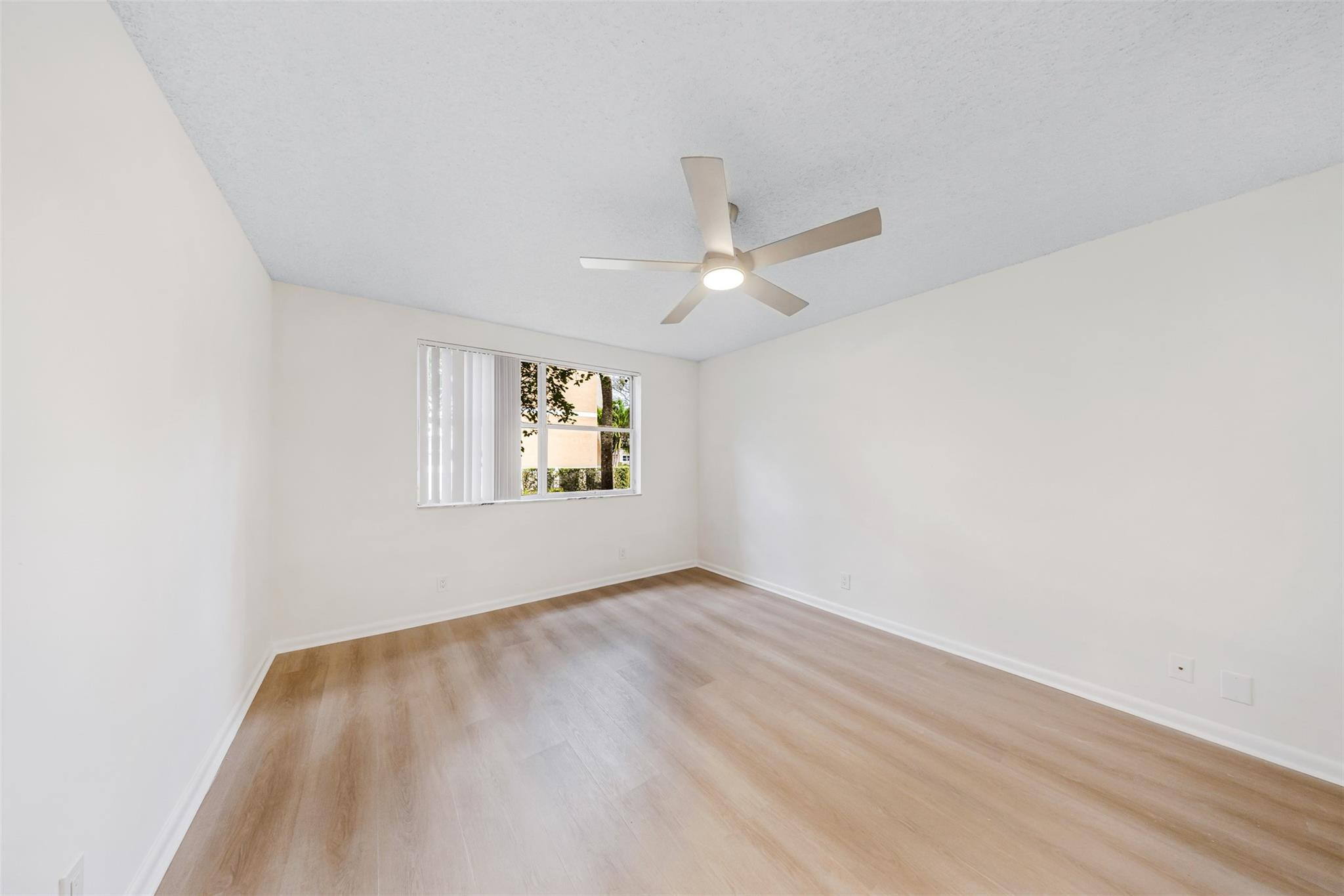 8977 Wiles Road, Unit 102 Coral Springs, FL 33067 - Photo 17 of 37 an empty room with a window
