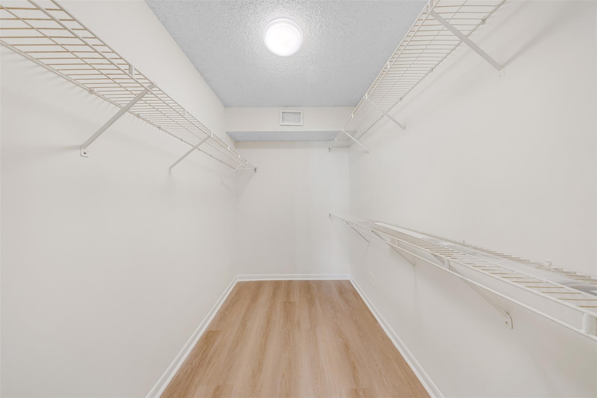 8977 Wiles Road, Unit 102 Coral Springs, FL 33067 - Photo 21 of 37 a view of a room with racks on the wall