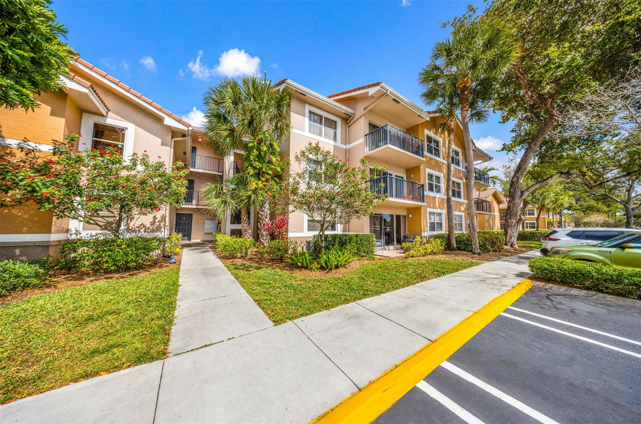 8977 Wiles Road, Unit 102 Coral Springs, FL 33067 - Photo 29 of 37 a view of a building with a yard