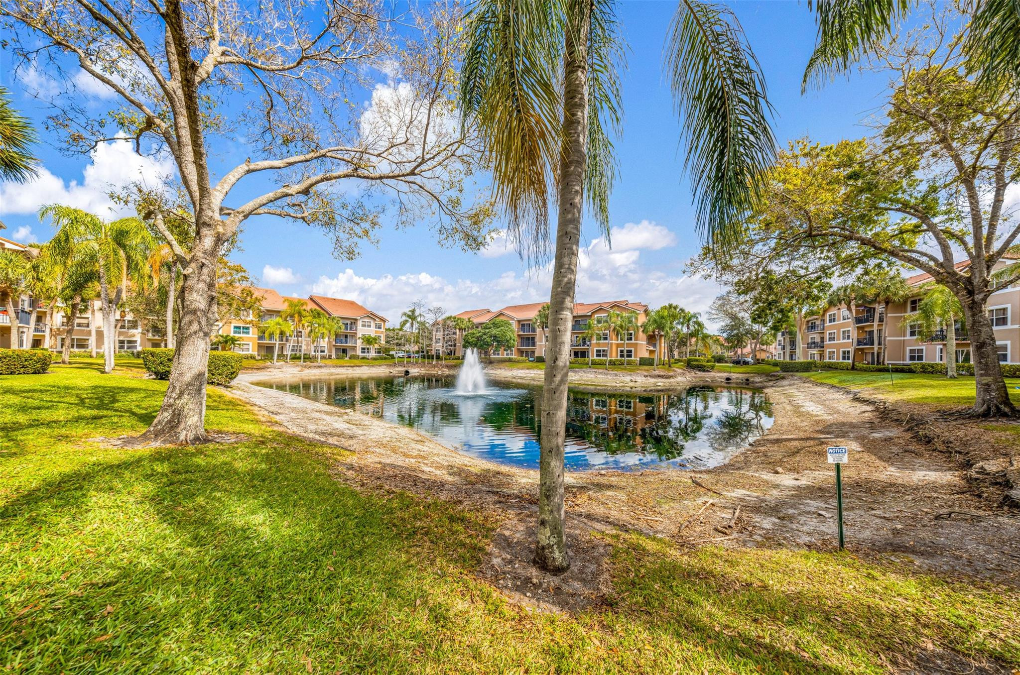 8977 Wiles Road, Unit 102 Coral Springs, FL 33067 - Photo 32 of 37 a view of a swimming pool with an ocean view