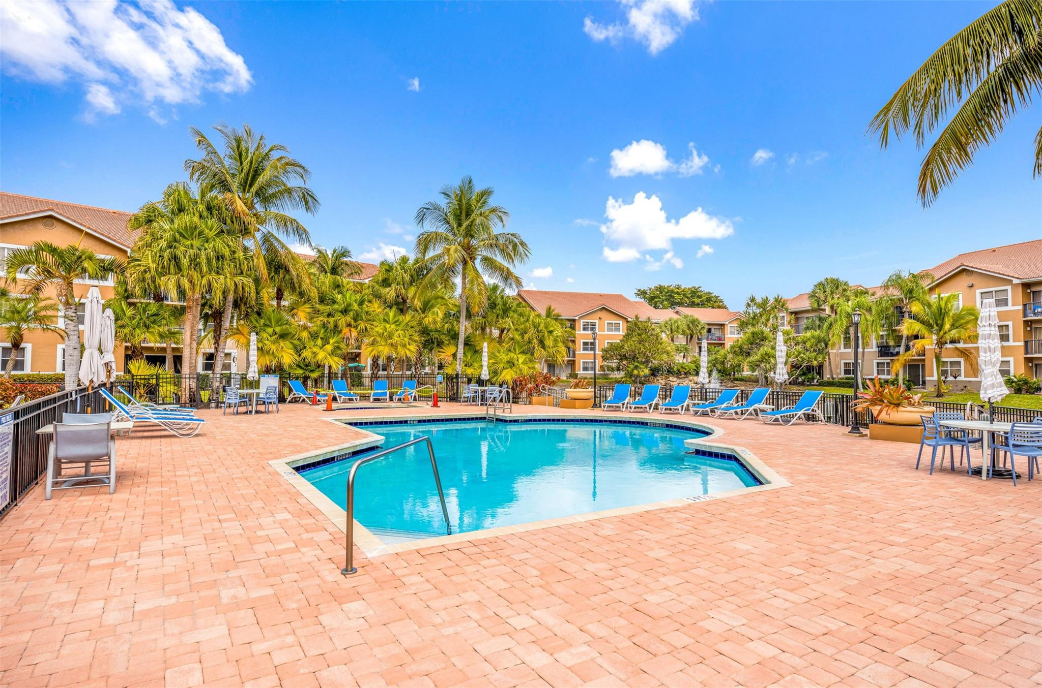 8977 Wiles Road, Unit 102 Coral Springs, FL 33067 - Photo 33 of 37 a view of a swimming pool with outdoor seating