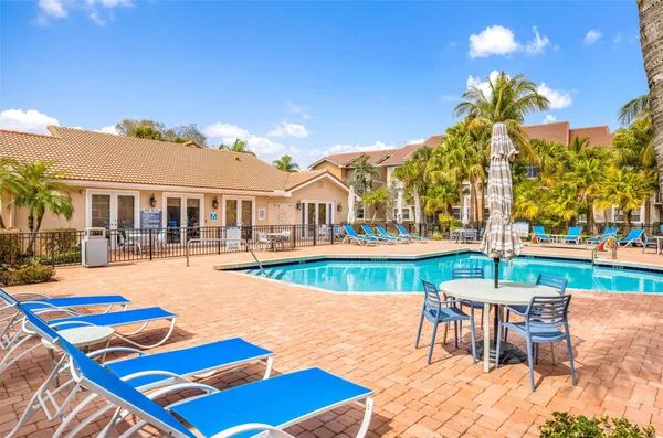 a view of a patio with swimming pool table and chairs