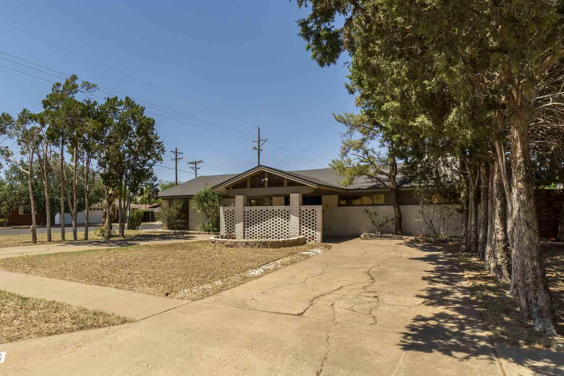 2136 57th Street Lubbock, TX 79412 - Photo 38 of 41 a view of a house with a yard covered with snow in the background