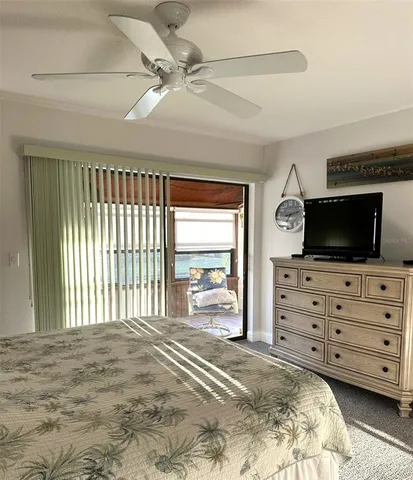 a bedroom with a bed a flat screen tv and a couch