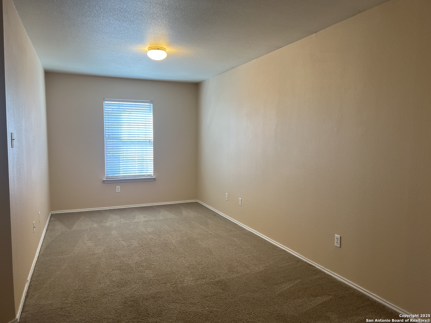 8163 Heights Valley Converse, TX 78109 - Photo 11 of 13 an empty room with a window and a fireplace