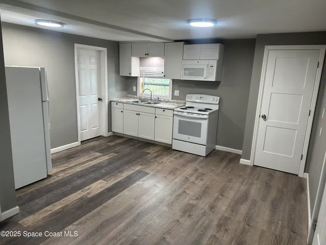 a kitchen with stainless steel appliances a refrigerator sink and stove