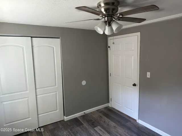 a view of a livingroom with a chandelier fan