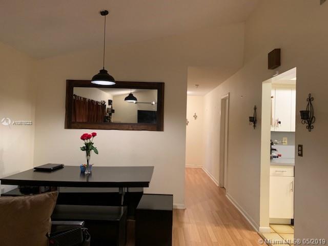 11495 Southwest 109th Road, Unit 11A Miami, FL 33176 - Photo 3 of 12 Dining area, hallway to bedrooms and guest bathroom , kitchen view from dining area