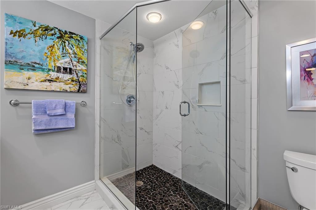 5899 Chanteclair Drive, Unit 214 Naples, FL 34108 - Photo 11 of 24 a bathroom with a shower