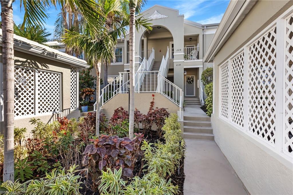 5899 Chanteclair Drive, Unit 214 Naples, FL 34108 - Photo 15 of 24 a view of a pathway of a house with a flower garden