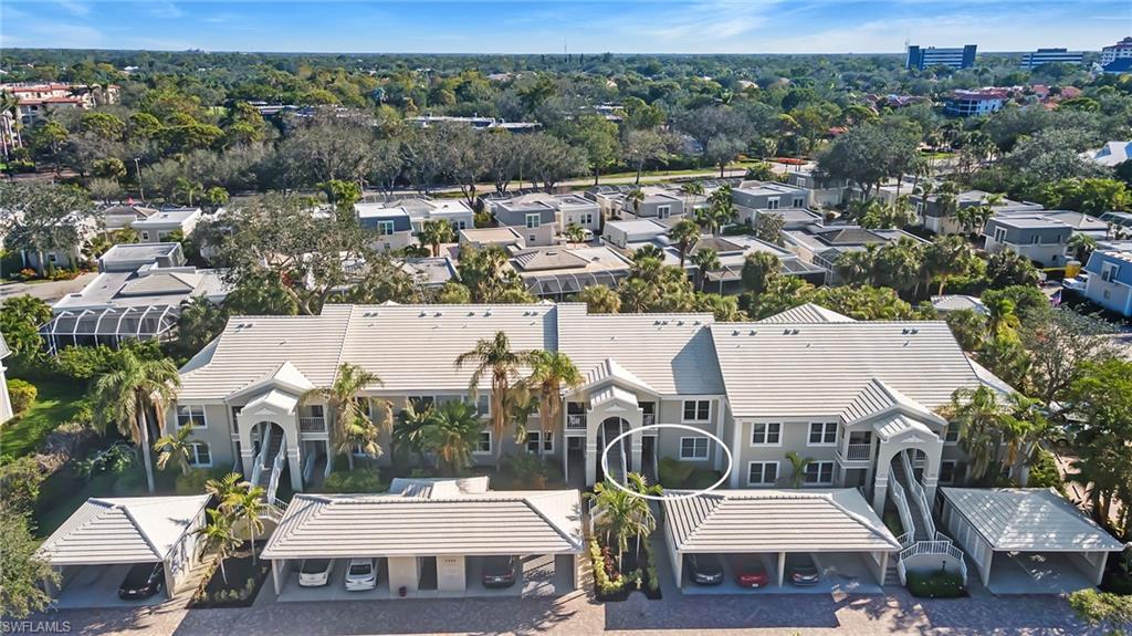 5899 Chanteclair Drive, Unit 214 Naples, FL 34108 - Photo 18 of 24 a view of a city that has tall buildings