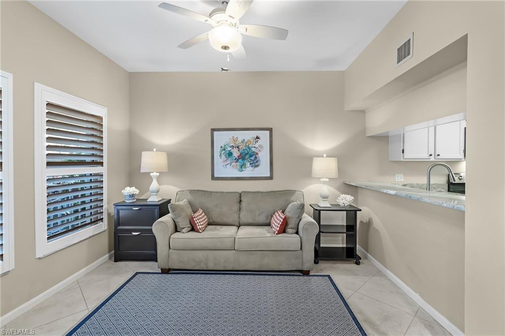5899 Chanteclair Drive, Unit 214 Naples, FL 34108 - Photo 2 of 24 a living room with furniture and a window