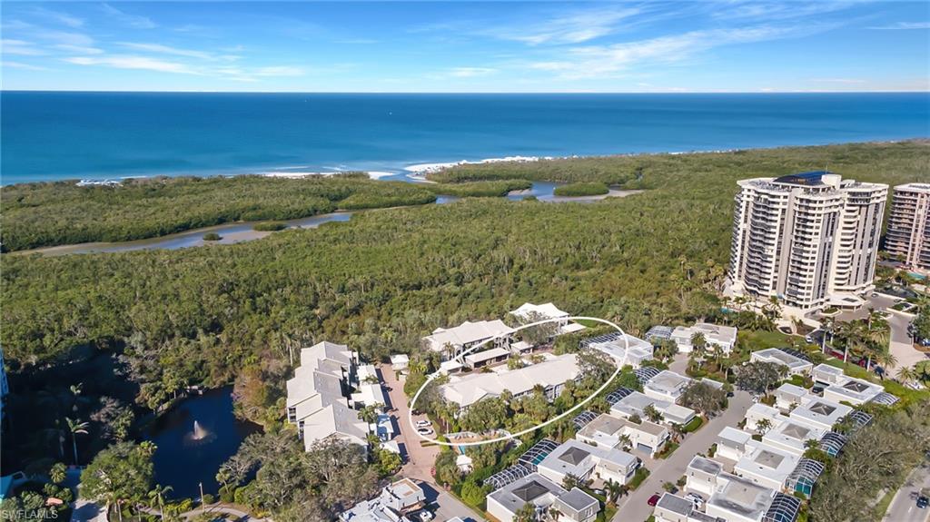 5899 Chanteclair Drive, Unit 214 Naples, FL 34108 - Photo 24 of 24 a view of a lake with a city