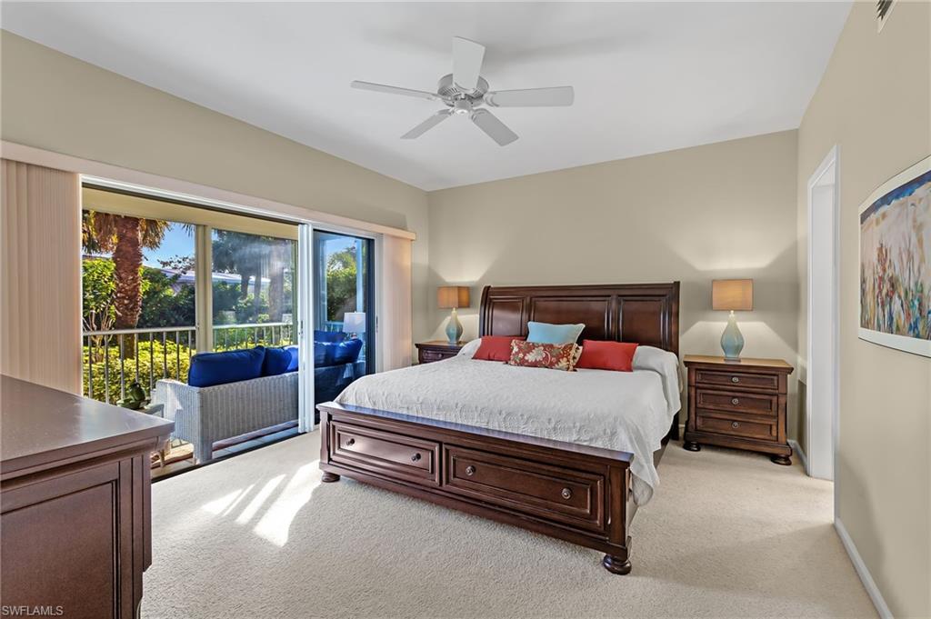 5899 Chanteclair Drive, Unit 214 Naples, FL 34108 - Photo 9 of 24 a bedroom with a bed and a couch