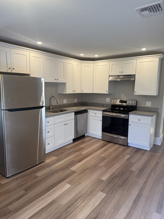 113 Union Street, Unit 2 Bridgewater, MA 02324 - Photo 3 of 9 a kitchen with granite countertop a sink stove and refrigerator