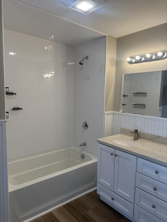 113 Union Street, Unit 2 Bridgewater, MA 02324 - Photo 4 of 9 a bathroom with a tub sink a mirror a vanity and shower