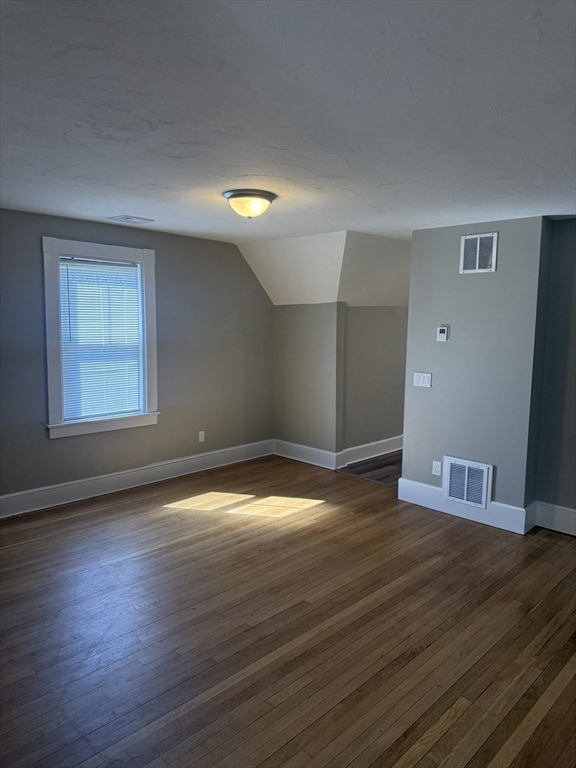 113 Union Street, Unit 2 Bridgewater, MA 02324 - Photo 5 of 9 a view of empty room with wooden floor and fan