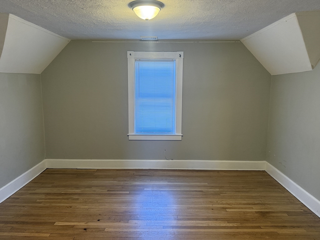 113 Union Street, Unit 2 Bridgewater, MA 02324 - Photo 6 of 9 a view of a room with wooden floor and window