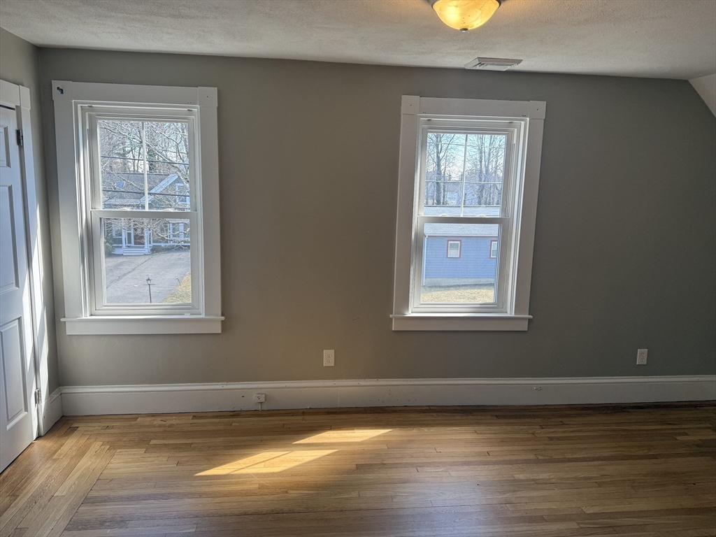 113 Union Street, Unit 2 Bridgewater, MA 02324 - Photo 7 of 9 a view of a room with wooden floor and windows