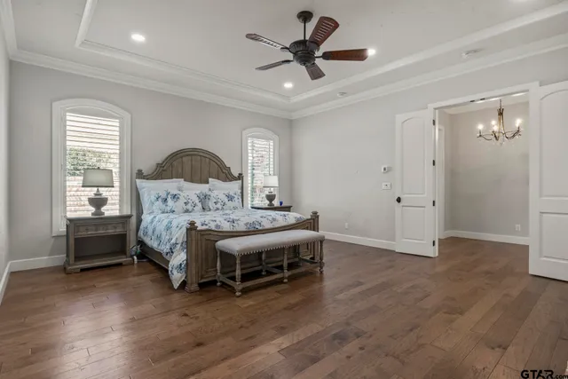 a bedroom with a bed and a ceiling fan